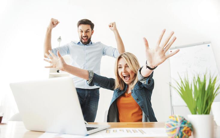 Cheerful young office workers are expressing happiness