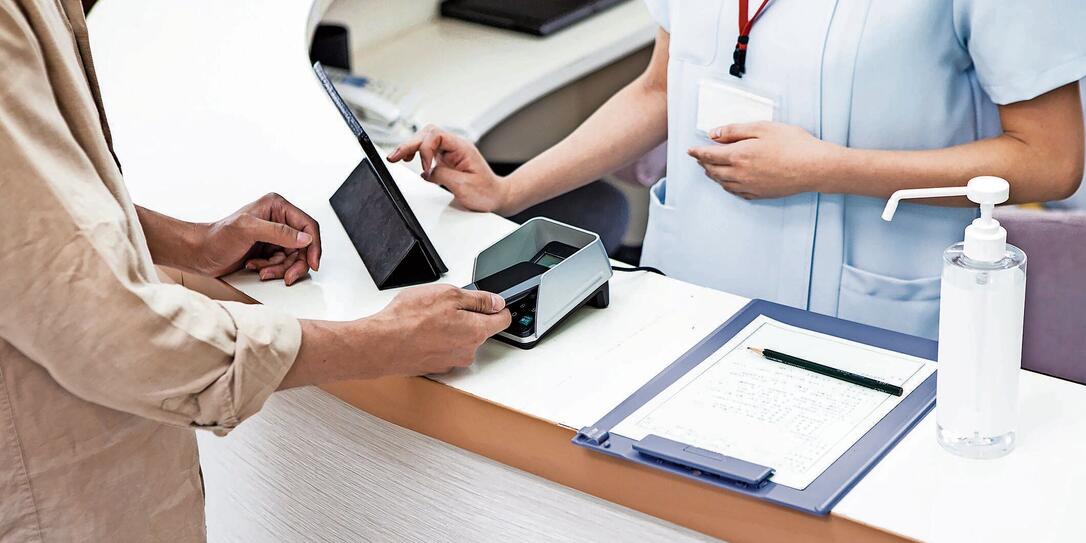 A man paying at a hospital using a smartphone