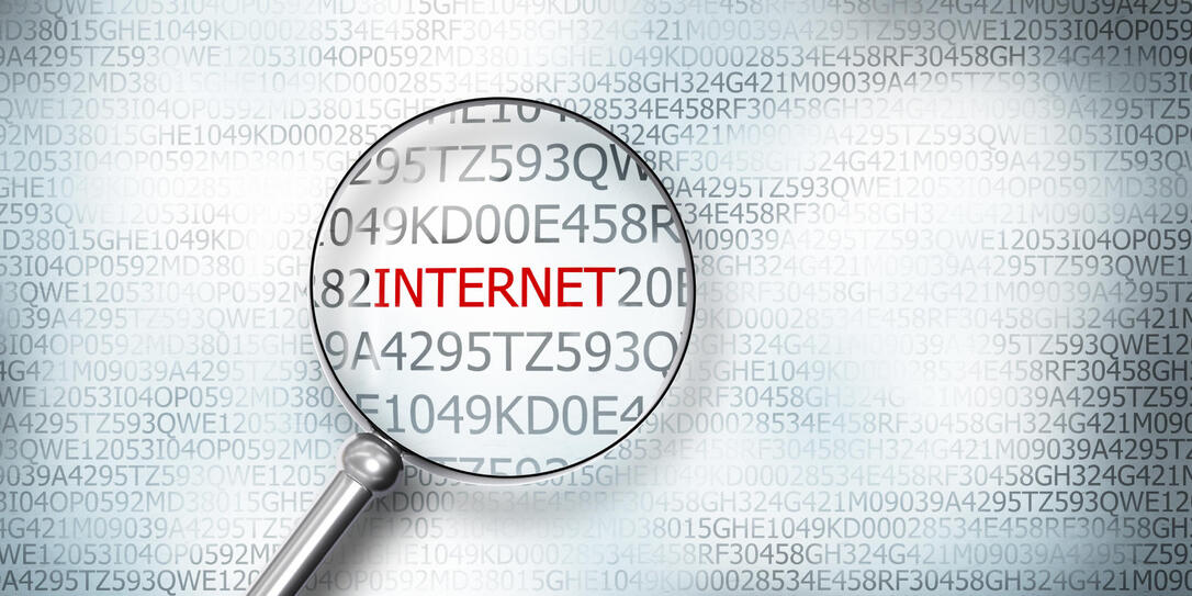 reading the word internet on computer screen with a magnifying glass