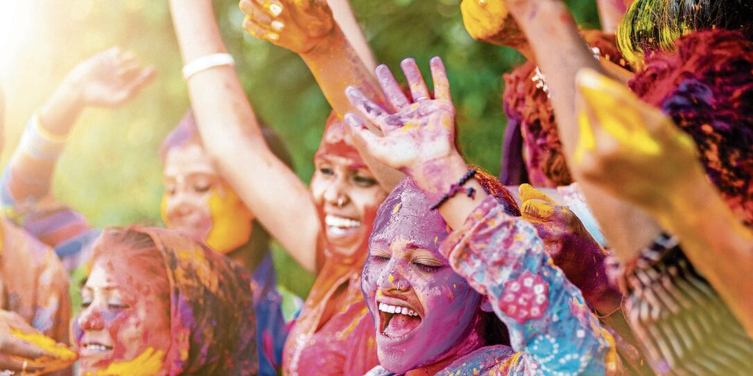Indian women throwing colored Holi powder Indian women throwing colored Holi powder