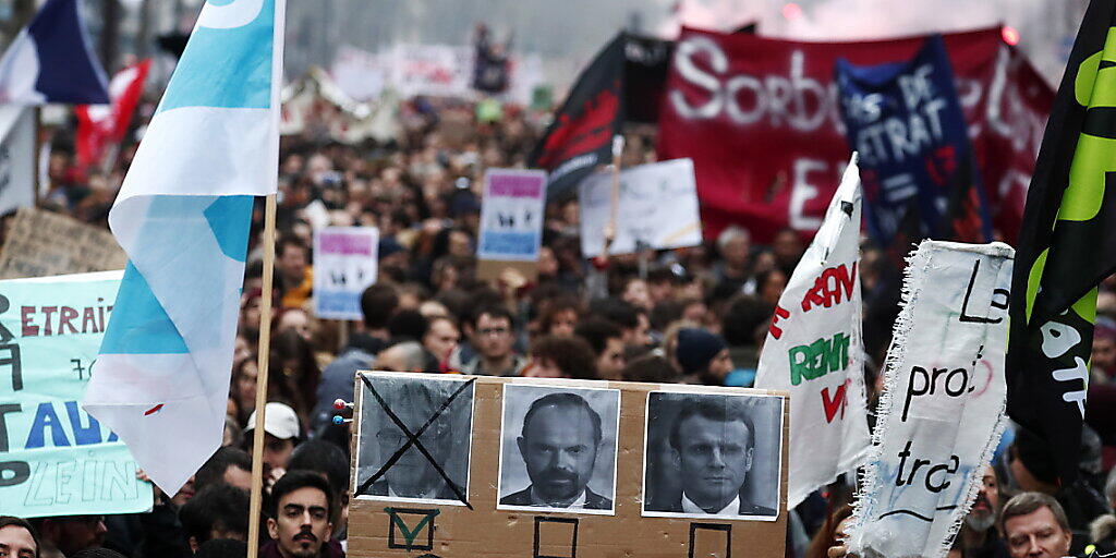 Demonstranten in Paris fordern den Rücktritt von Premierminister Edouard Philippe und Präsident Macron. Links auf dem Plakat ist Jean-Paul Delevoye abgebildet, der Rentenbeauftragte der Regierung trat am Montag nach Enthüllungen über zahlreiche Nebenjobs zurück. Demonstranten in Paris fordern den Rücktritt von Premierminister Edouard Philippe und Präsident Macron. Links auf dem Plakat ist Jean-Paul Delevoye abgebildet, der Rentenbeauftragte der Regierung trat am Montag nach Enthüllungen über zahlreiche Nebenjobs zurück.