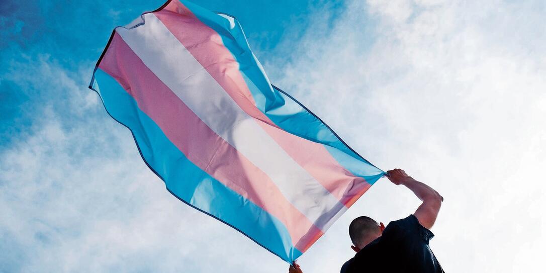 young person with a transgender pride flag