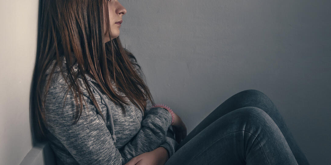 Portrait of a sad teenage girl looking thoughtful about troubles