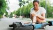Young woman suffering from knee pain after e-scooter riding accident