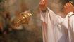 Priest incenses the altar with incense during Holy Mass