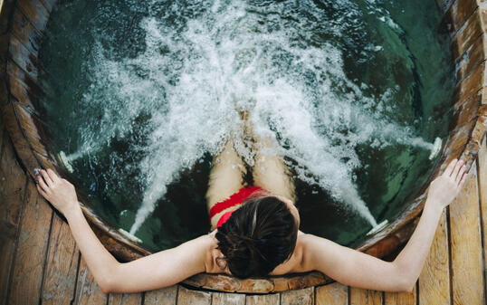 Woman relaxing in the outdoor spa