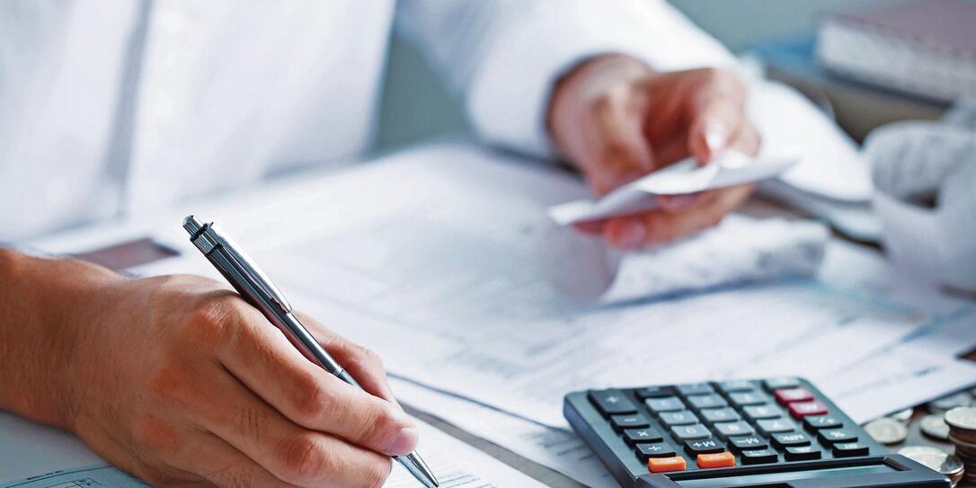 Man hand filling US tax form. tax form us business income office Financial document. Tax time.Tax concept. Close-up.