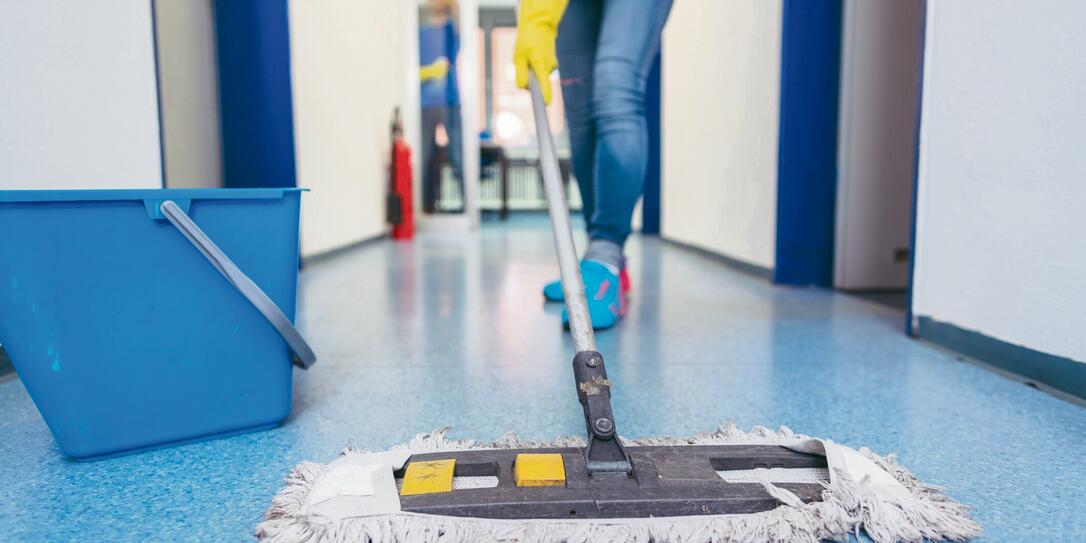 Close-up of cleaners moping the floor Close-up of cleaners moping the floor