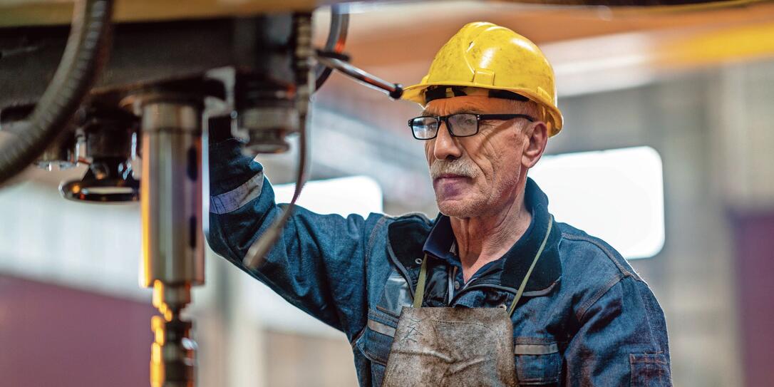 Turner worker working on drill bit in a workshop