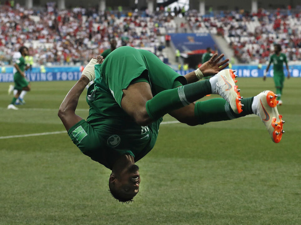 Saudi Arabia's Salem Aldawsari celebrates with a flip after scoring his side's second goal during the group A match between Saudi Arabia and Egypt at the 2018 soccer World Cup at the Volgograd Arena in Volgograd, Russia, Monday, June 25, 2018. (AP Photo/Darko Vojinovic)