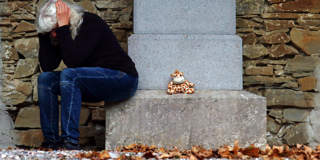 A grieving woman in a cemetery