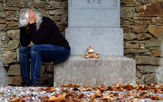A grieving woman in a cemetery