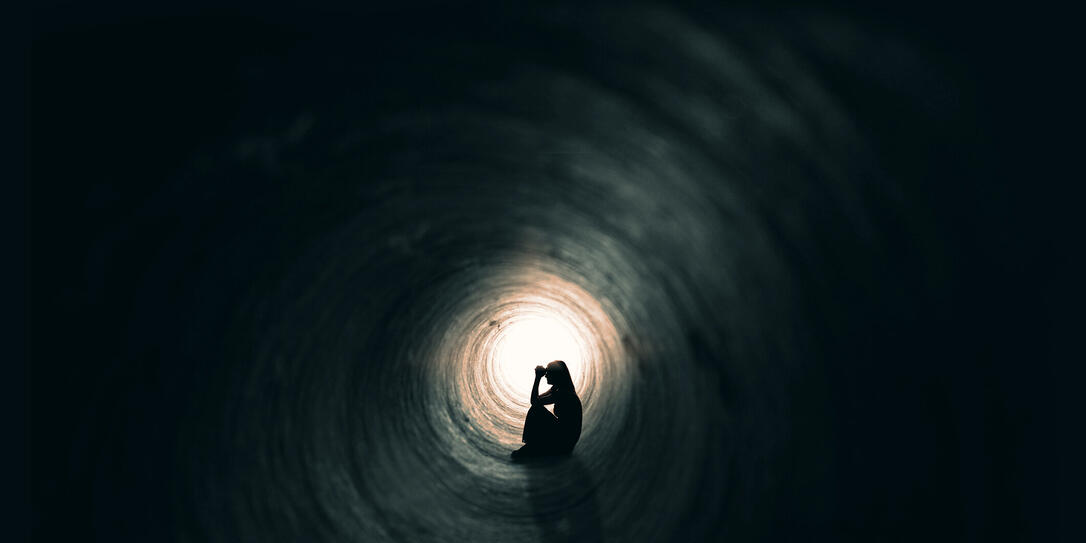 Woman Praying In A Dark Place