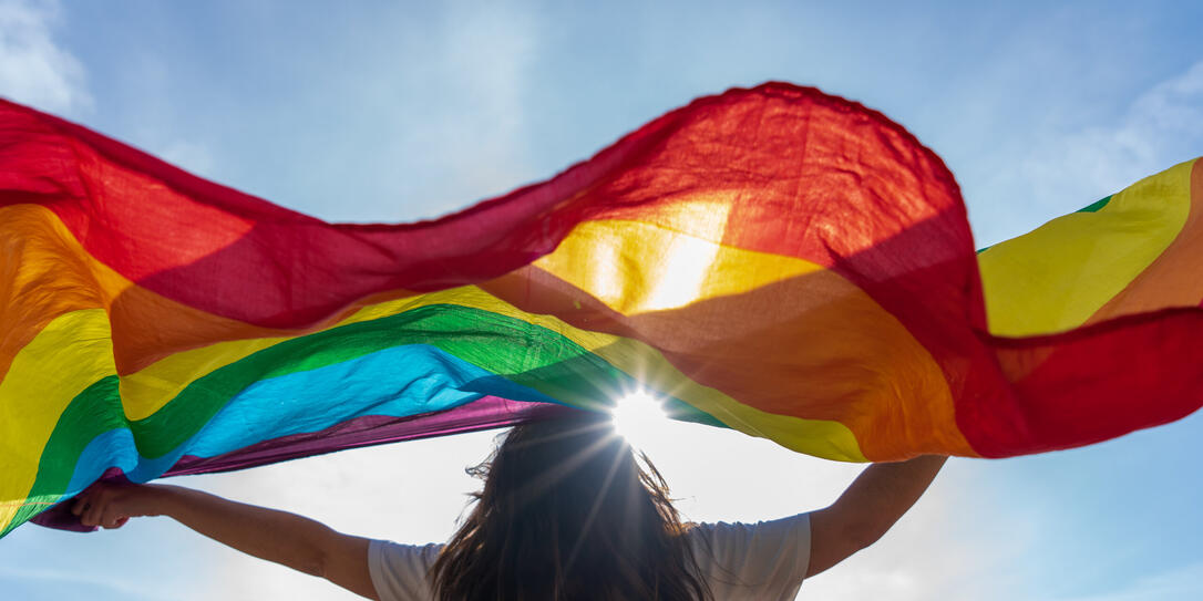 Young woman waving lgbti flag