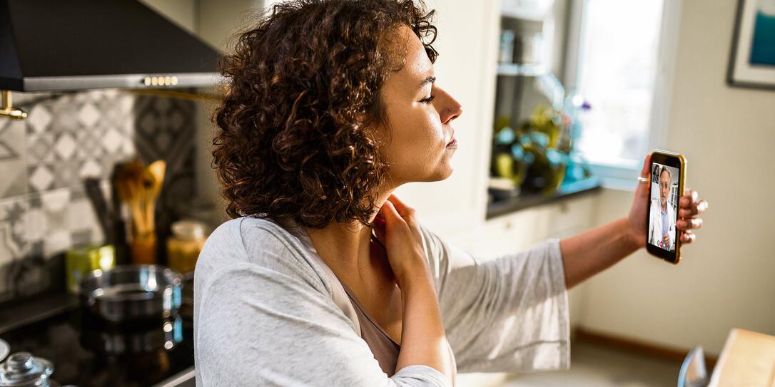 Young woman talking to her doctor on a video call