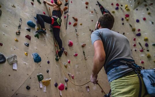 Climbing coach giving instructions.