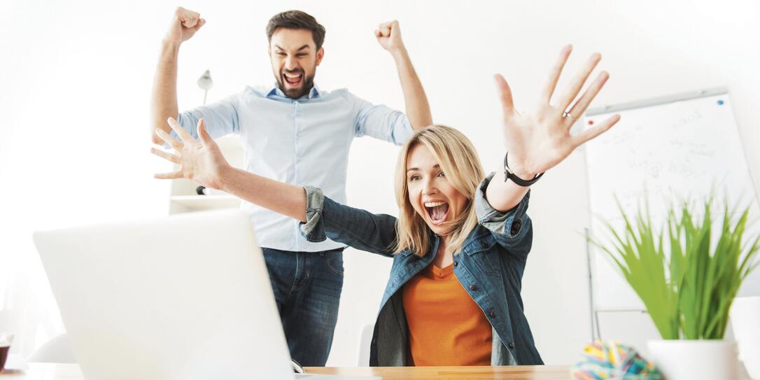 Cheerful young office workers are expressing happiness