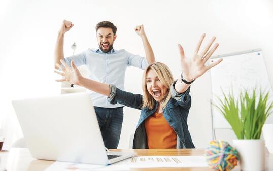 Cheerful young office workers are expressing happiness