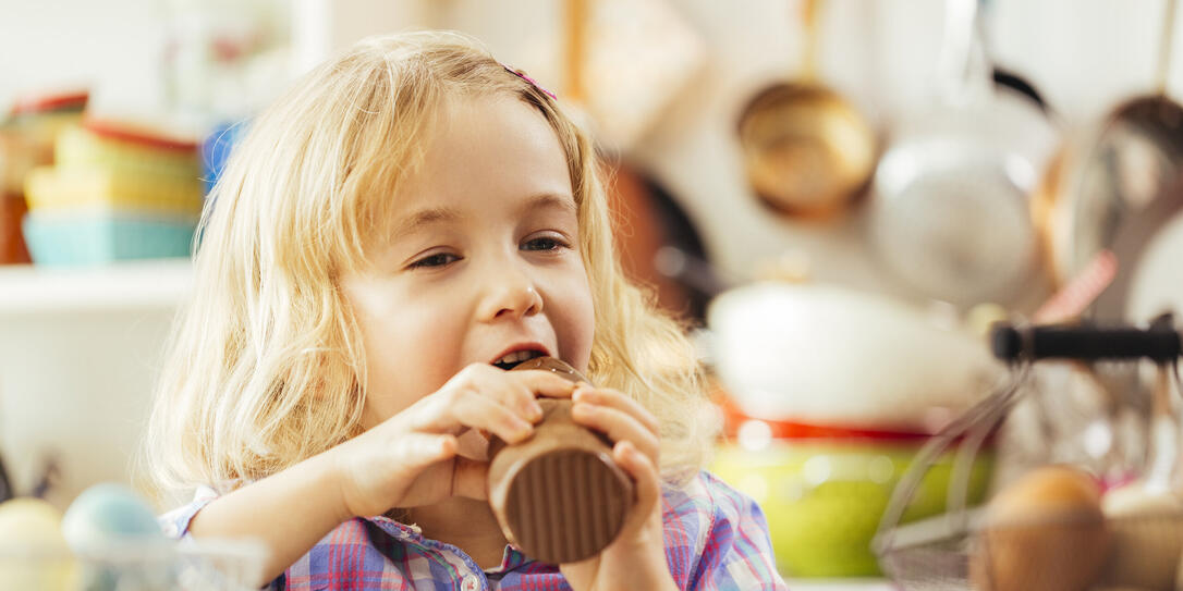 Little Girl Eating Chocolate Easter Bunny