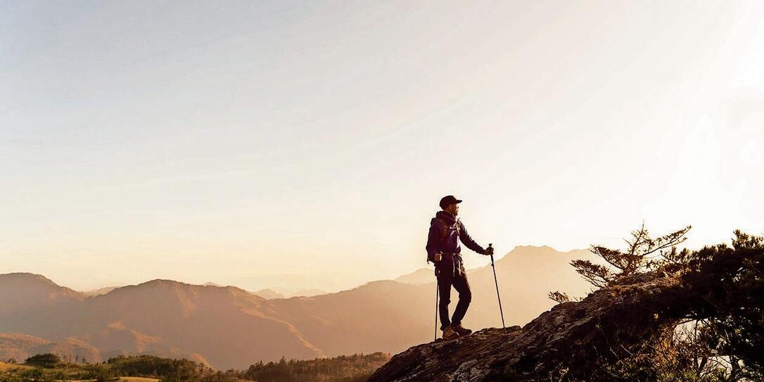 A man hiking with a view from the rock