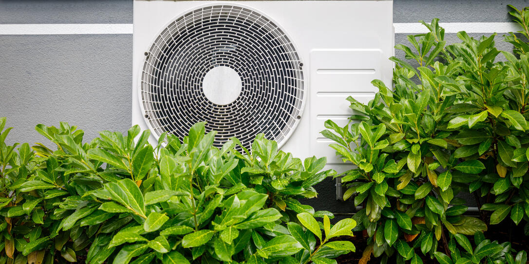 Air heat pumps beside house