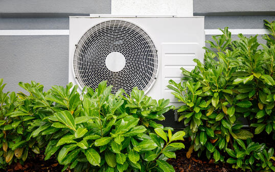 Air heat pumps beside house