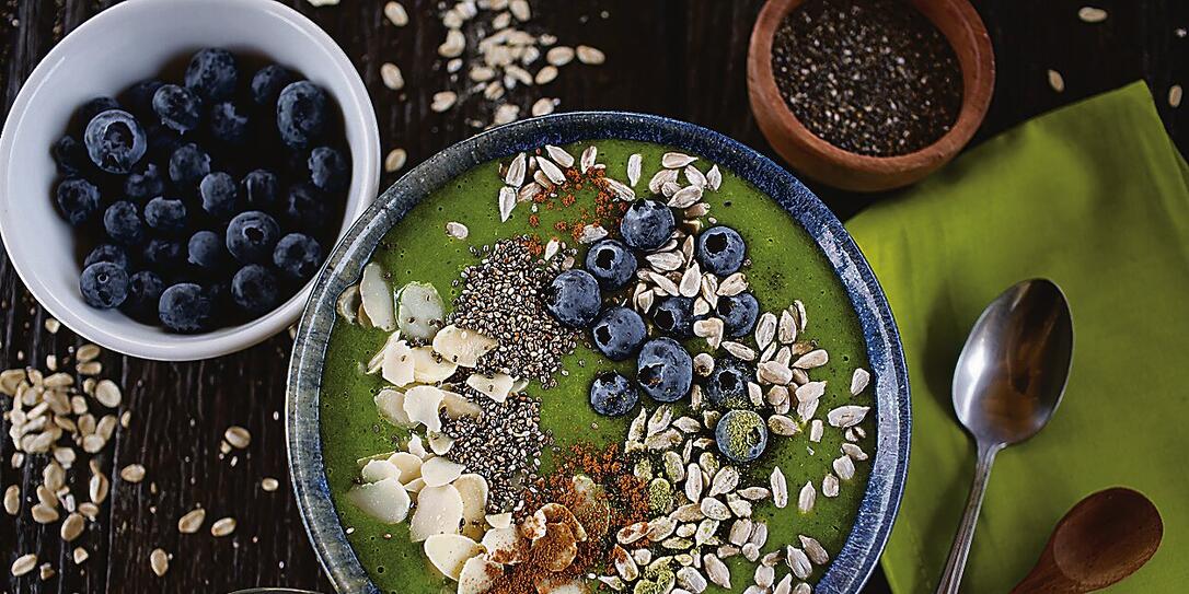 Green smoothie bowl with almonds, blueberries, chia and sunflower seeds Green smoothie bowl with almonds, blueberries, chia and sunflower seeds