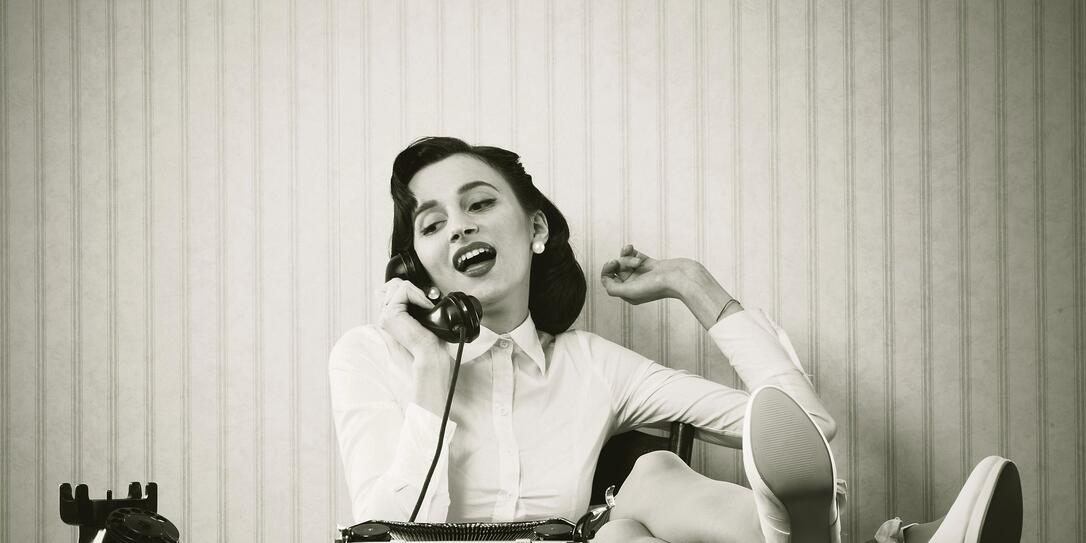 Woman talking on phone at desk