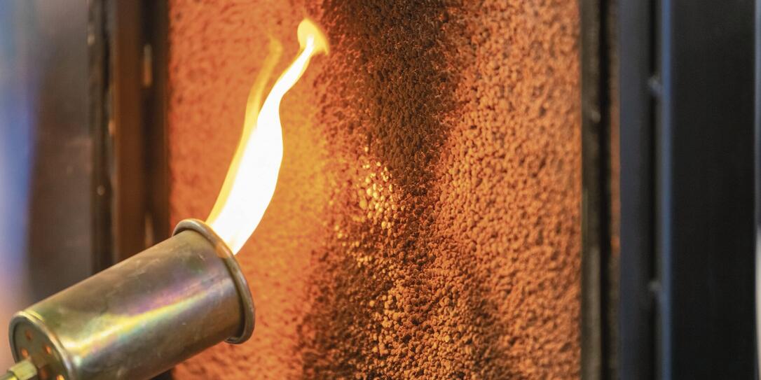 Close up of a flame torch testing flame retardant material, demonstrating fire resistance and safety in industrial applications