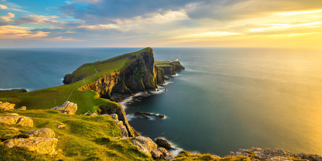 Beautiful golden light at sunset at Neist Point Lighthouse on the Isle of Skye, Scotland.