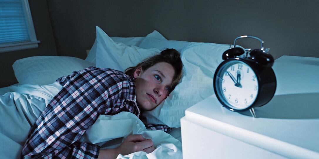 Sleepless Young Woman with Insomnia in Bed, Watching Alarm Clock