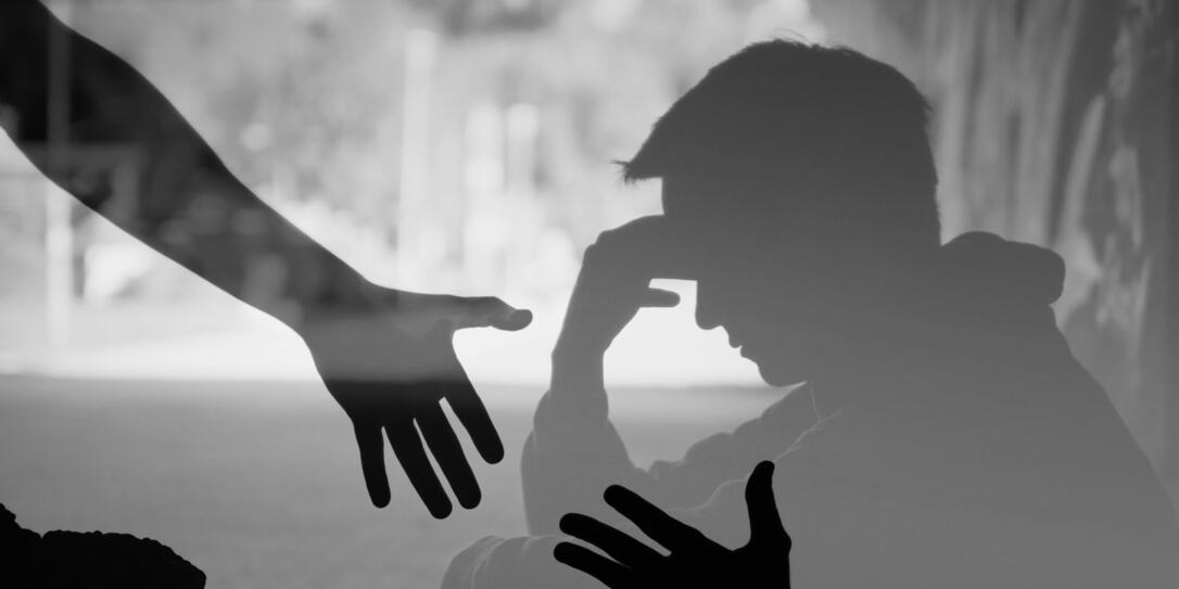 Man suffering from depression sadness needing a helping hand from a friend.