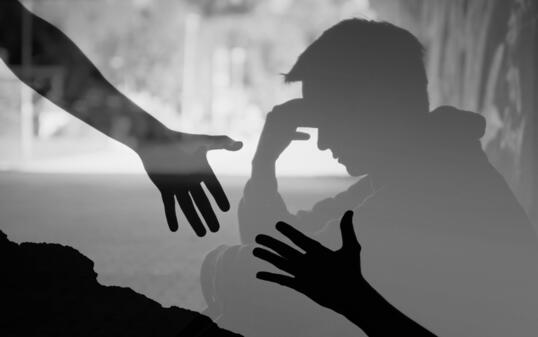 Man suffering from depression sadness needing a helping hand from a friend.