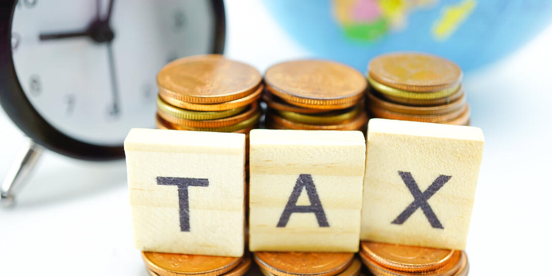 TAX alphabet with stack of coin and alarm clock : Time to pay.
