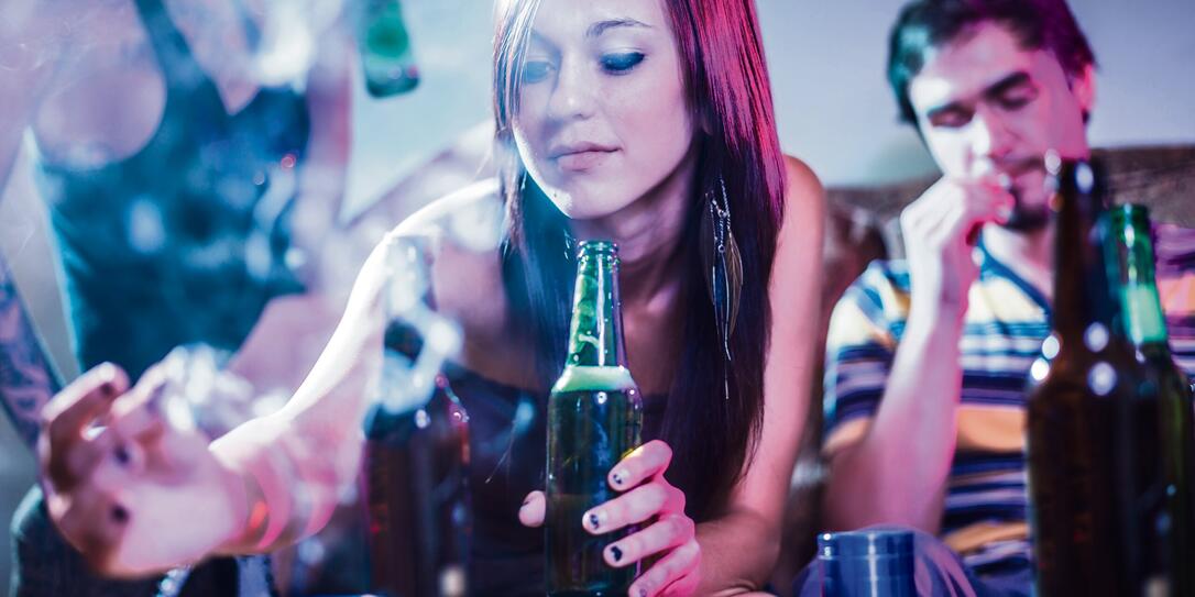 girl putting joint in ashtray at crazy party