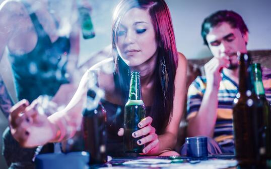 girl putting joint in ashtray at crazy party