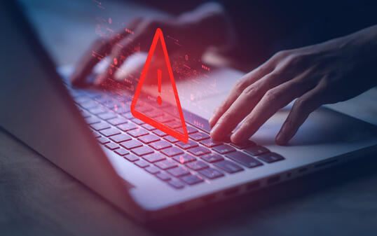 System hacked warning alert on notebook (Laptop). Cyber attack on computer network, Virus, Spyware, Malware or Malicious software. Cyber security and cybercrime. Compromised information internet.