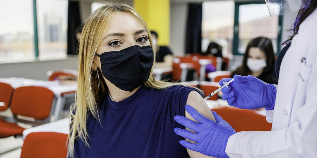 Nurse gives students a vaccination in school during coronavirus pandemic Nurse gives students a vaccination in school during coronavirus pandemic
