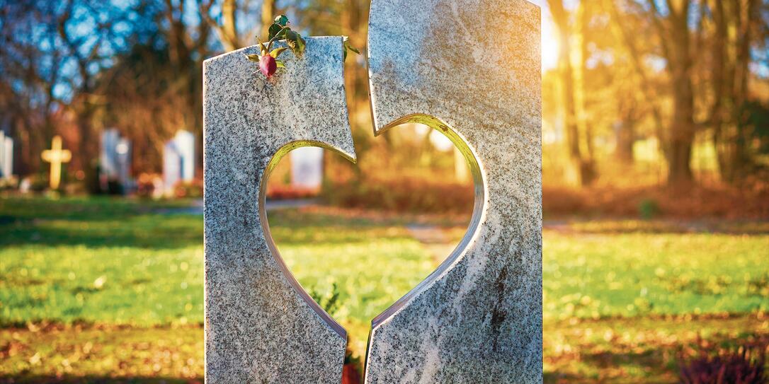 Gravestone with heart withered rose