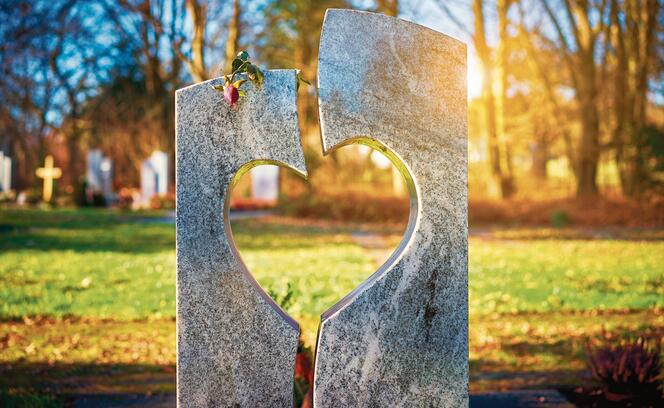 Gravestone with heart withered rose