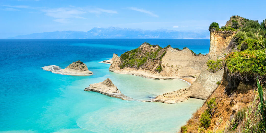 Cape Drastis cliffs near Sidari and Peroulades on Corfu island in Greece. Famous rock formations with small beach and rugged coastline. Popular Greek destination for summer vacation.