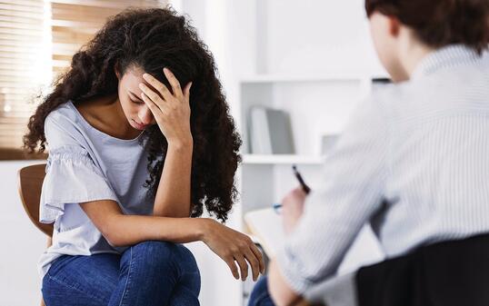 Professional psychotherapies and young woman suffering from ptsd