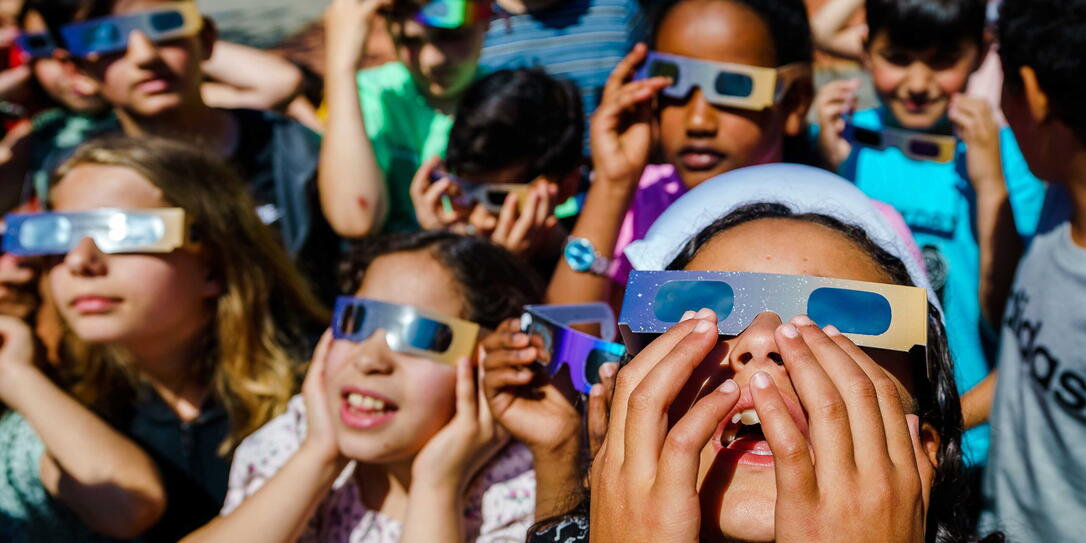 Students watch partial solar eclipse