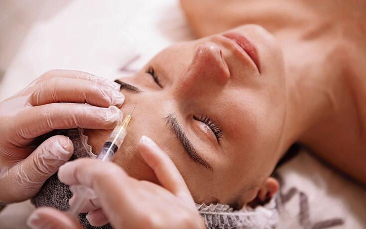 Beautiful young woman at cosmetology clinic