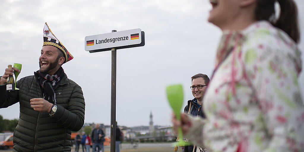 Menschen feiern den Abbau des Grenzzauns zwischen Kreuzlingen und Konstanz. Doch erst am 15. Juni sollen die Grenzen vollständig geöffnet werden.