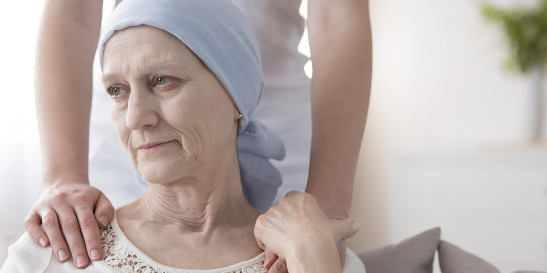 Crying elderly woman with cancer