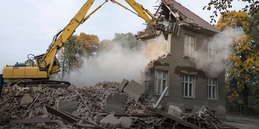 digger demolishing houses