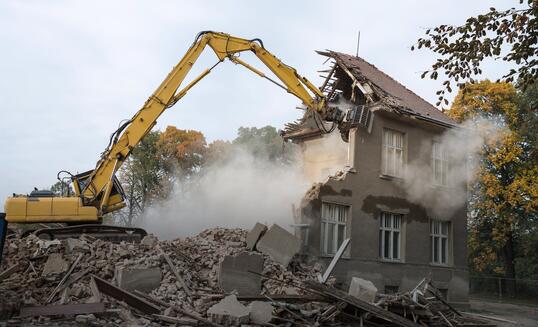 digger demolishing houses