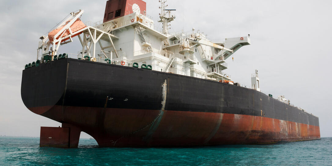 An oil tanker anchored near a petroleum terminal and offshore platform in Persian Gulf