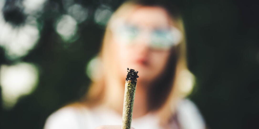 Woman holding marijuana joint
